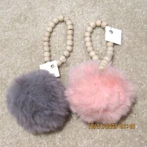 Pair of decorative pom-poms — perfect for adding a playful touch to any space.